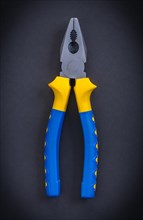 Aerial tongs with blue handles on a black background