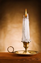 Copy the image of a burning candle in an old candlestick
