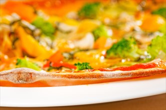 Fresh italian thin style vegetarian pizza with fresh mixed vegetables close up