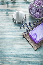 Bar of handmade soap lavender bunch aromatic bath sea salt jar cover on wood board healthcare concept