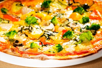 Fresh italian thin style vegetarian pizza with fresh mixed vegetables close up