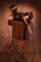 Brown giftbox on old wooden board