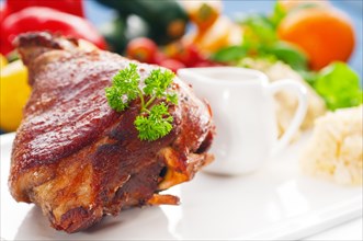 Original German BBQ pork knuckle served with mashed potatoes and sauerkraut