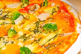 Fresh italian thin style vegetarian pizza with fresh mixed vegetables close up