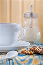 Cup dispenser and biscuits