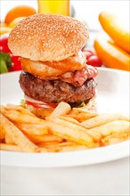 Classic american hamburger sandwich with onion rings and french fries