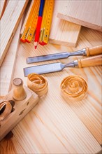 Carpentry tools wooden metre woodworkers plane chisels pencil shavings on boards