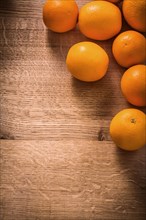 Fresh ripe orange fruits on vintage wooden board with organised copyspace