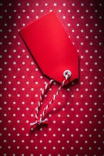 Red sale tag on polka-dot background