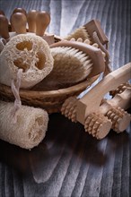 Peeling loofahs massage devices and nail brush on vintage wood background sauna concept