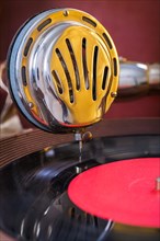 Gromophone speaker on vinyl disc close up