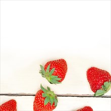 Fresh organic strawberry over white rustic wood table