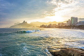 Sunset on Ipanema beach in the city of Rio de Janeiro with the mountains in the background