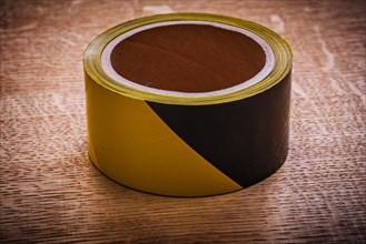 Safety tape on vintage brown wood board maintenance concept