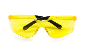 Yellow safety goggles against a white background