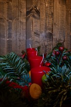 Red Advent candles on a festive Advent arrangement