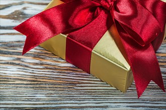 Golden present box on wooden board