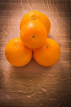 Aerial view of small pile of orange fruit on wooden board