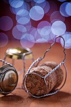 Champagne corks and wires on wooden table and beautiful blue background