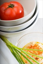 Fresh healthy hummus with tomato and chives typical middle east dish