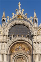 Magnificent main facade of St Mark's Basilica decorated with frescoes and sculptures