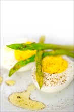 Boiled fresh green asparagus and eggs with extra virgin olive oil