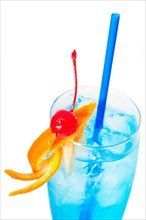 Blue long drink cocktail with orange and cherry garnish and blue straw