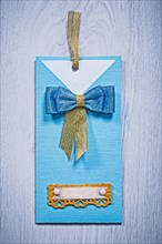Blue invitation envelope on a grey wooden background