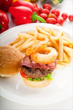 Classic american hamburger sandwich with onion rings and french fries