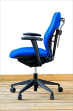 Modern blue office chair on wood floor over white background