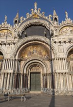 Magnificent main facade of St Mark's Basilica decorated with frescoes and sculptures