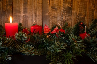 Red Advent candles on a festive Advent arrangement