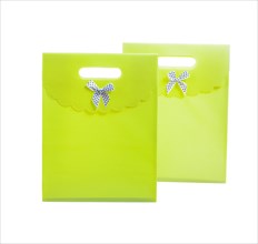 Two green paper bags against a white background
