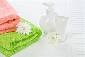 Bath accessories with flower on towel