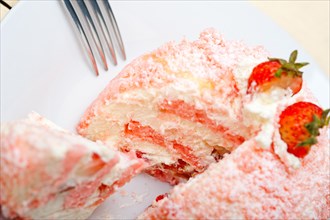 Fresh pink strawberry and whipped cream dessert macro close up