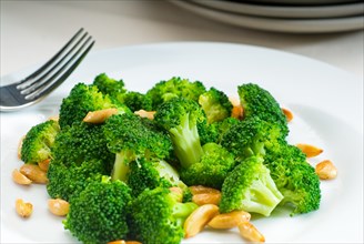Fresh and vivid sauteed broccoli and almonds very ealthy food