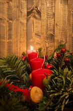 Red Advent candles on a festive Advent arrangement