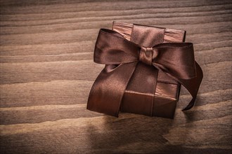 Boxed glittery gift container on vintage wooden board