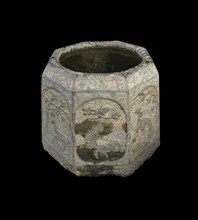 Ancient stone bucket finely carved with iced water over black backgroungd