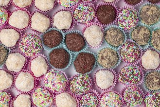 Light and dark rum balls with various sprinkles photographed from above