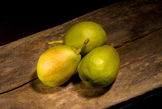 Autumn fresh pears over old wood board