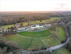 Aerial view of a spa building with neighbouring park in the evening