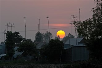 Sunset behind roofs and old television aerials