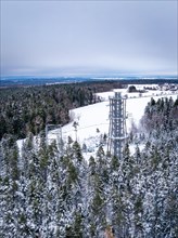 Bird's eye view of an observation tower in a snowy forest