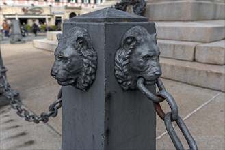Lion heads on a barrier at a monument