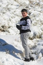 Young latin guy in sportswear in the snow
