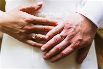Detail of hands of bride and groom with rings at a wedding