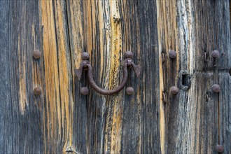 Old wooden door with aged metal door handle. Architectural textured background