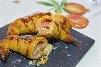 Freshly baked croissants stuffed with ham and melted cheese