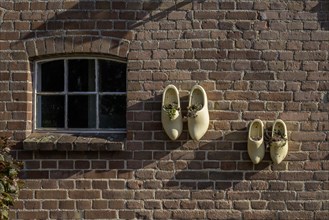 Wooden shoes as decoration on a stable wall